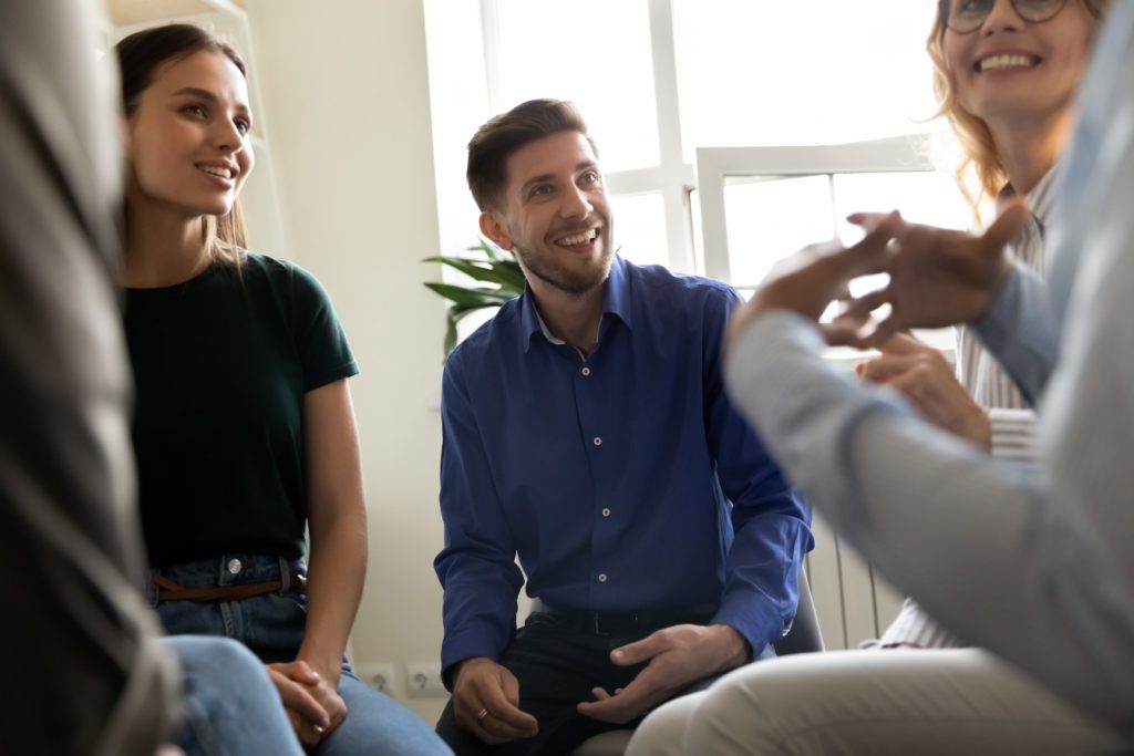 Group of people in circle smiling